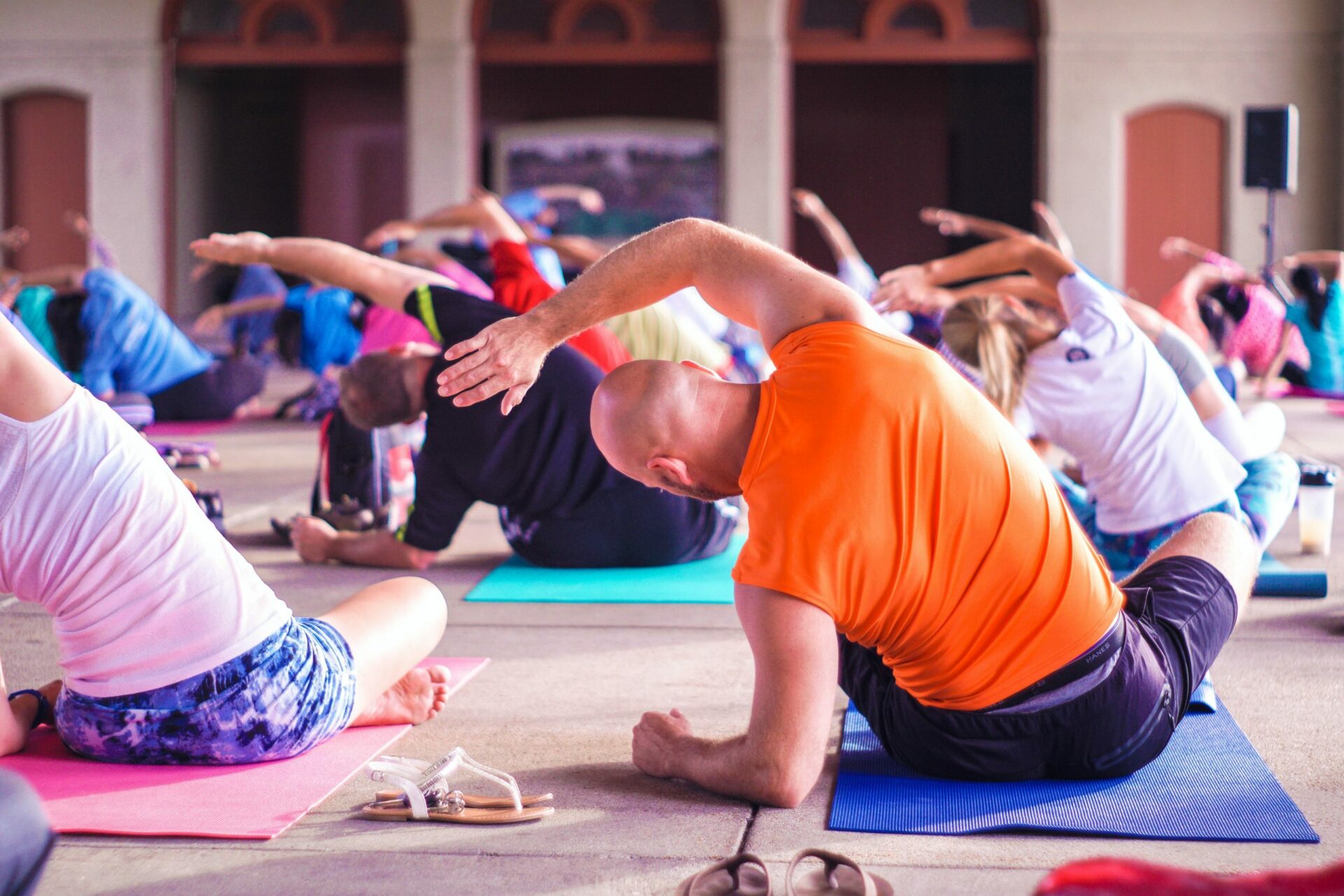 a group of people doing yoga in a gym.