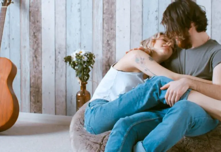 a man and a woman sitting on a bean bag chair.