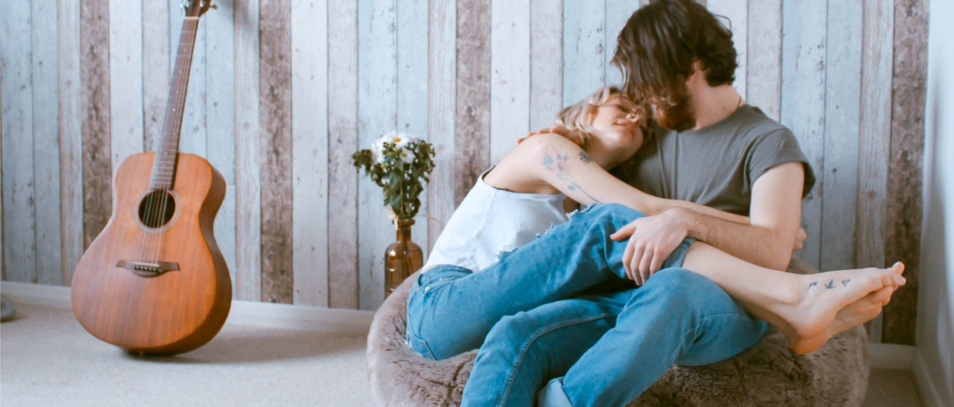 a man and a woman sitting on a bean bag chair.