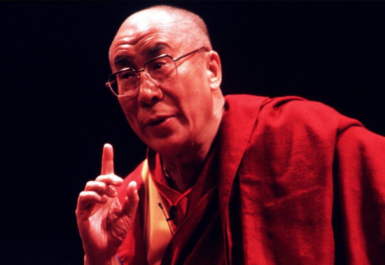 a man in a red robe is pointing at something.