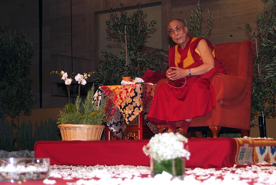 Dalai Lama speaking in front of an audience