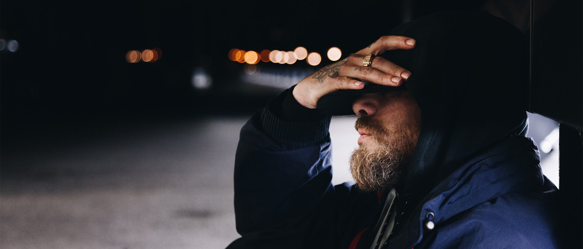 a man with a beard and a ring on his finger.