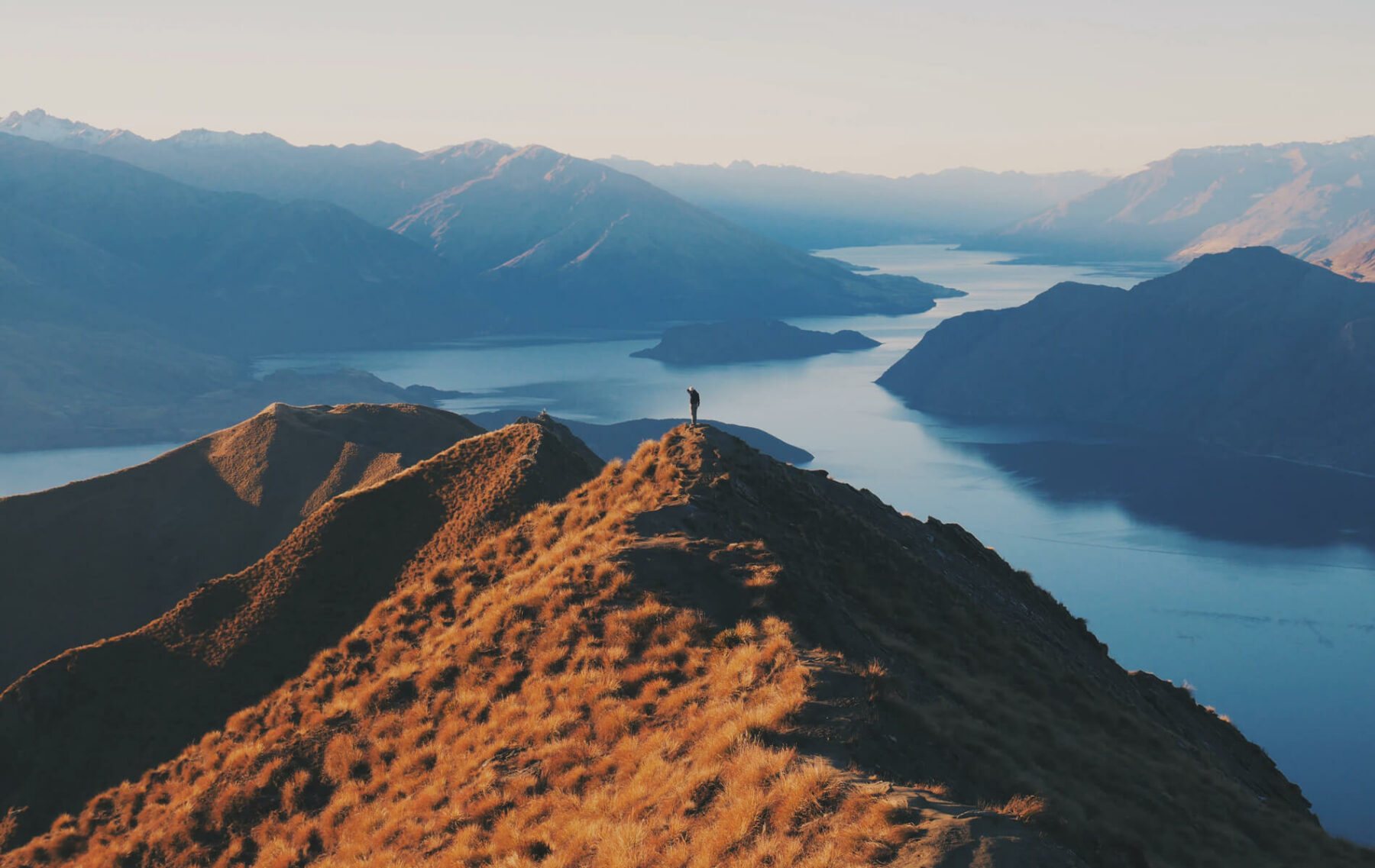 a person standing on top of a mountain.