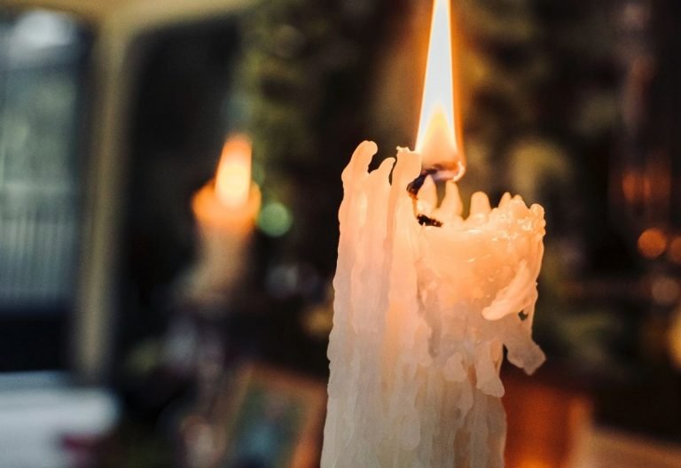 a lit candle sitting on top of a table.