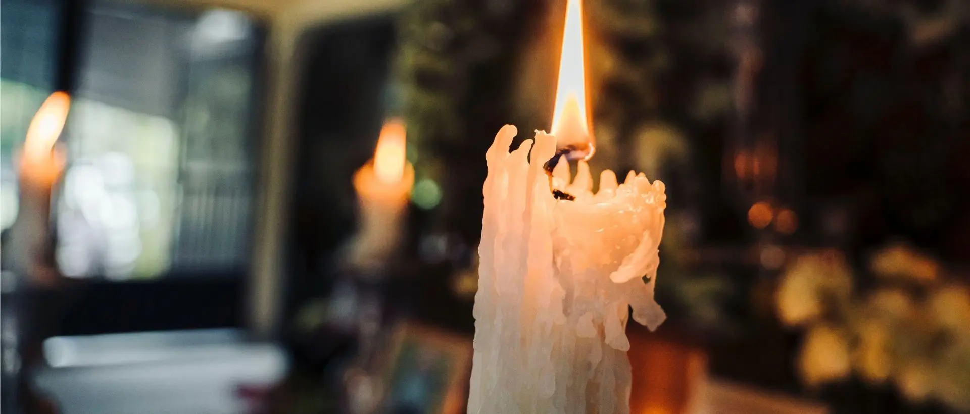 a lit candle sitting on top of a table.