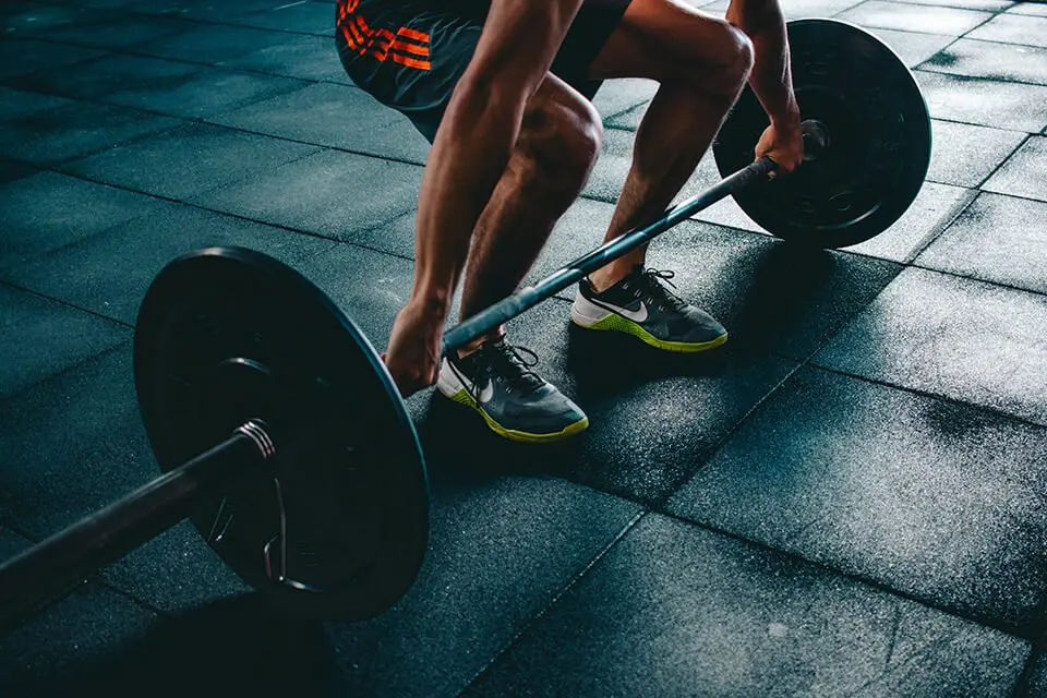 Man attempting a deadlift at a gym