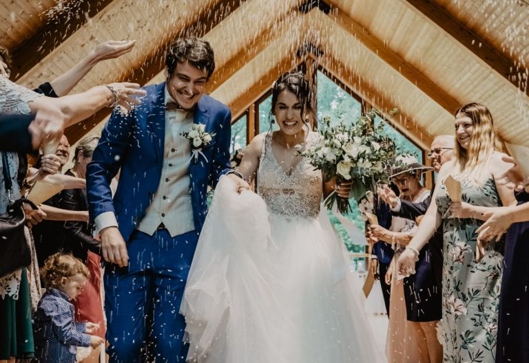 a bride and groom walking down the aisle.