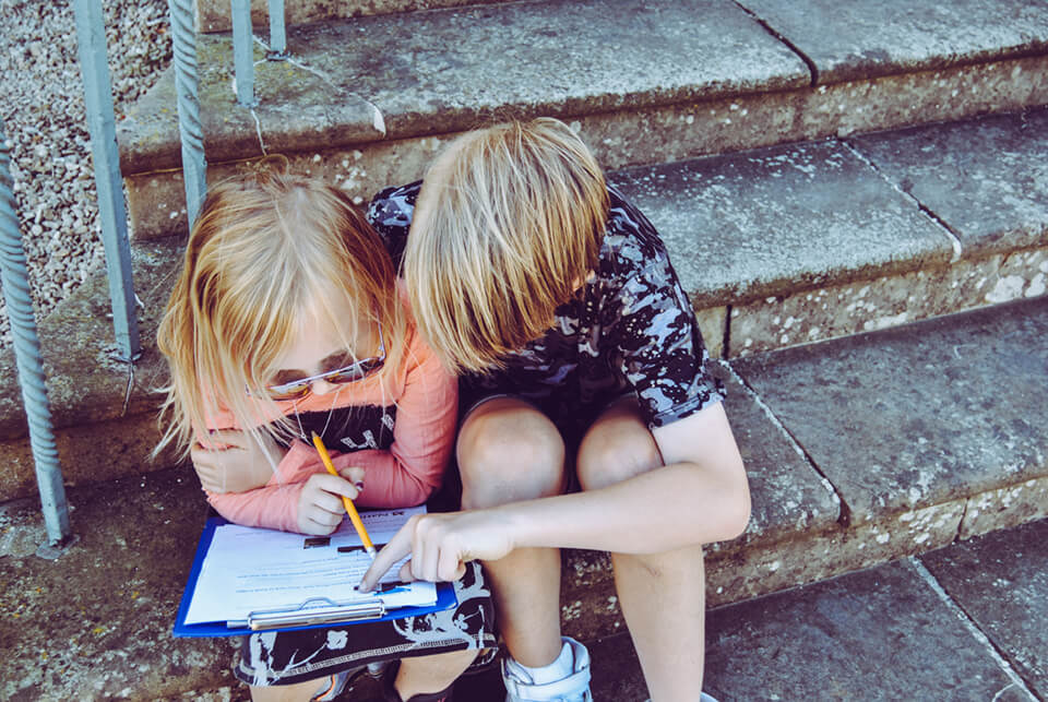 Boy helping a girl out with filling a form