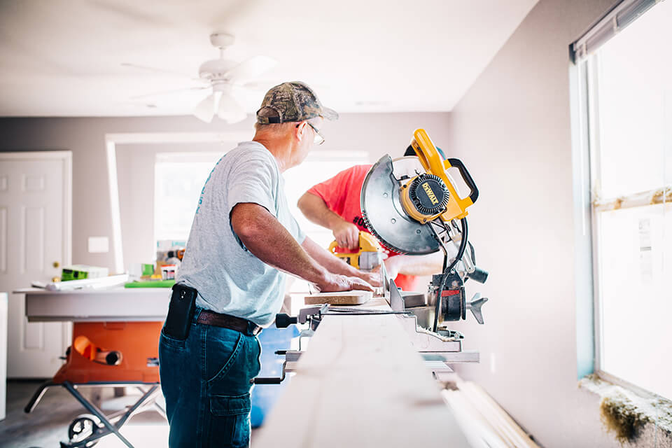 Two men working on a construction project in their home