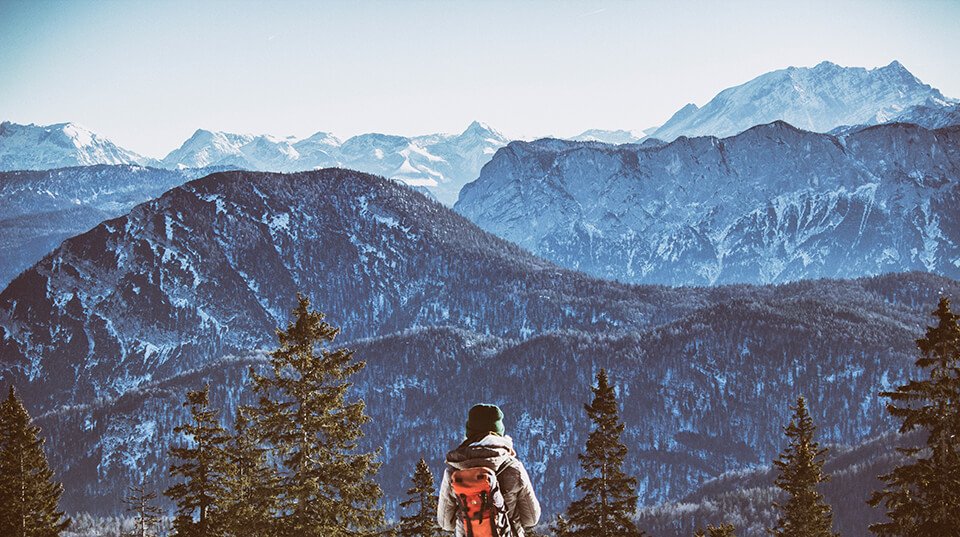 Man looking out into the distance of mountains