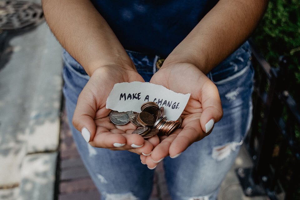 Someone holding out a pile of coins