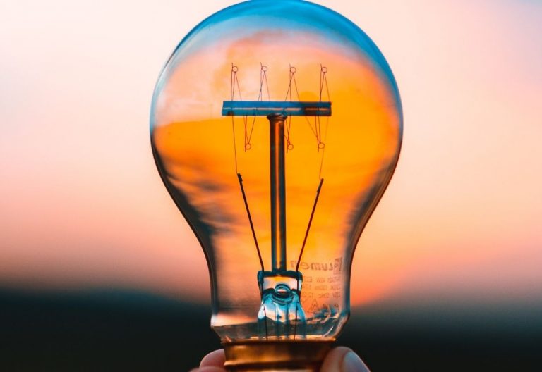 a person holding a light bulb in their hand.