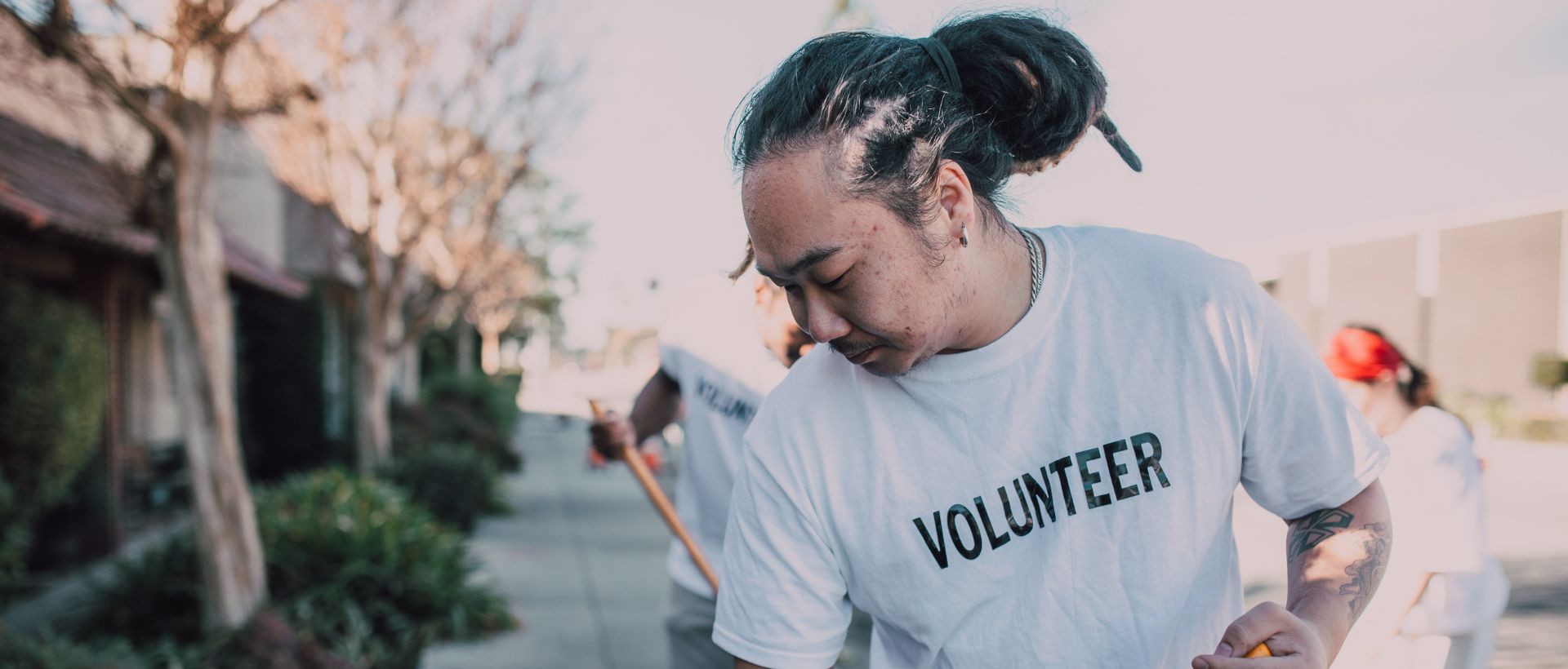 a man holding a baseball bat while wearing a volunteer t - shirt.