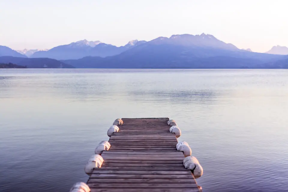 Overlooking a still lake on a pier