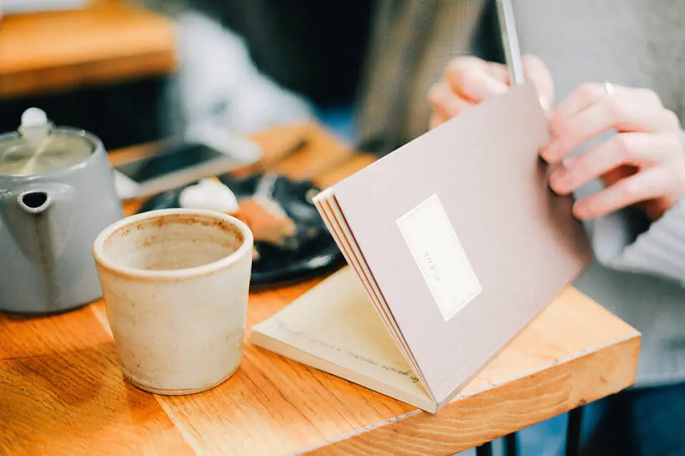 Woman using a notebook to plan her day