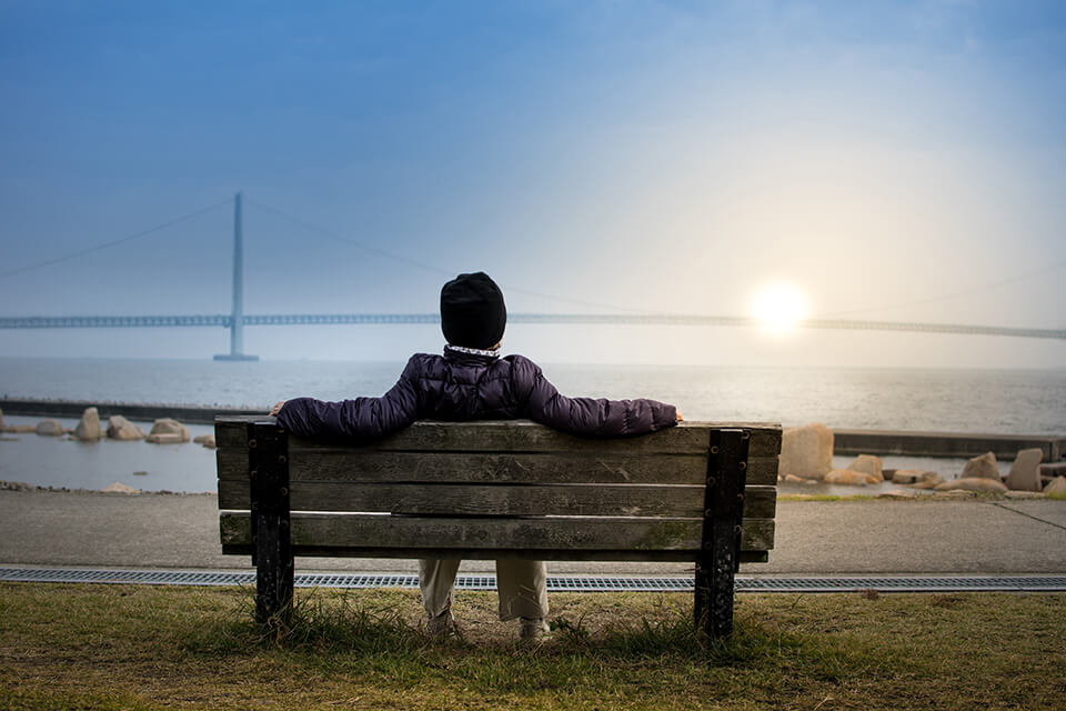 Man sitting and resting on a bench in a park