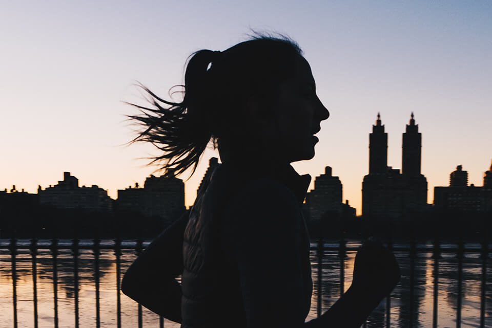 Woman running by the water