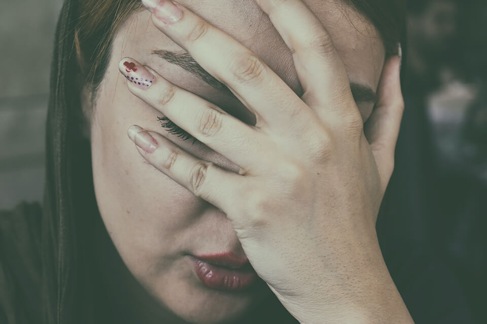 Woman with her head in her hands