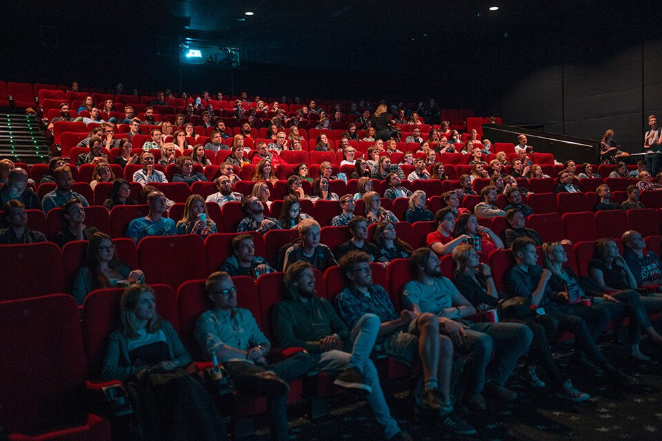 Watching something funny at a movie theater