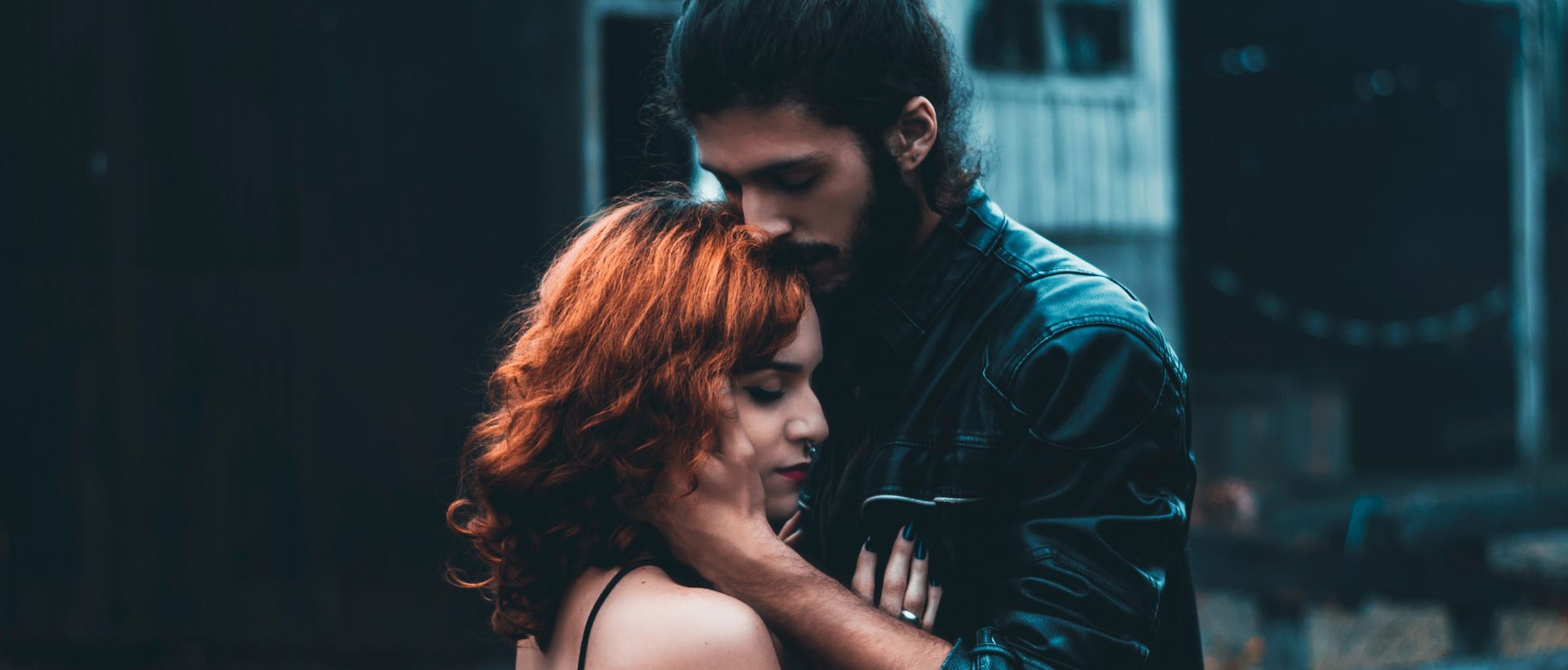 a man standing next to a woman with red hair.