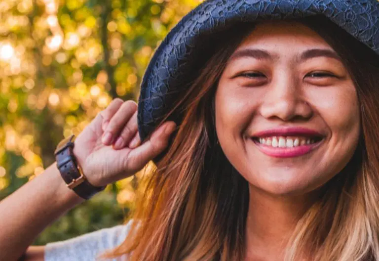 a woman with long hair wearing a hat.