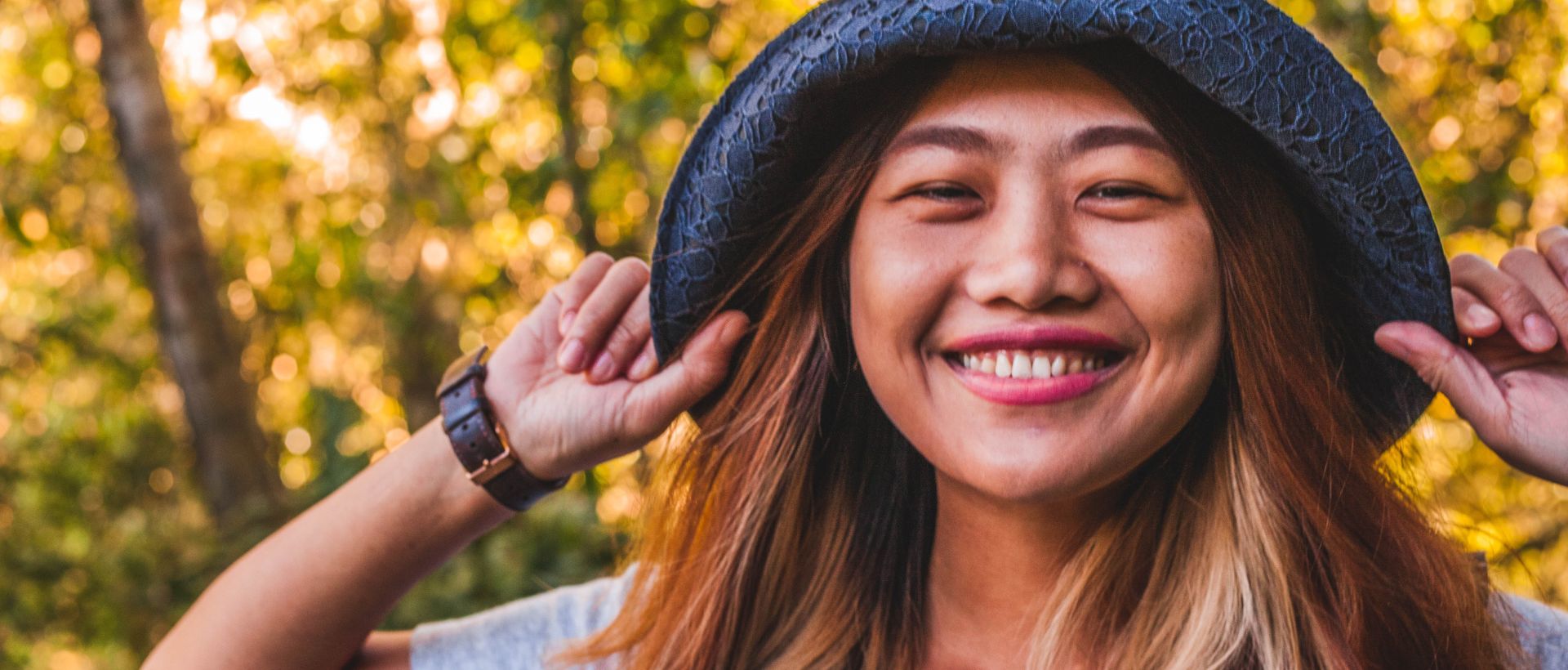 a woman with long hair wearing a hat.