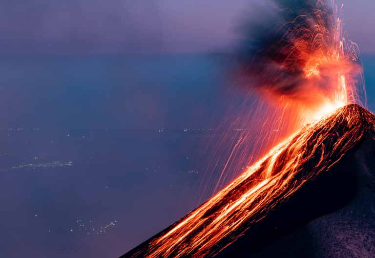 a volcano erupts lava as it erupts into the air.