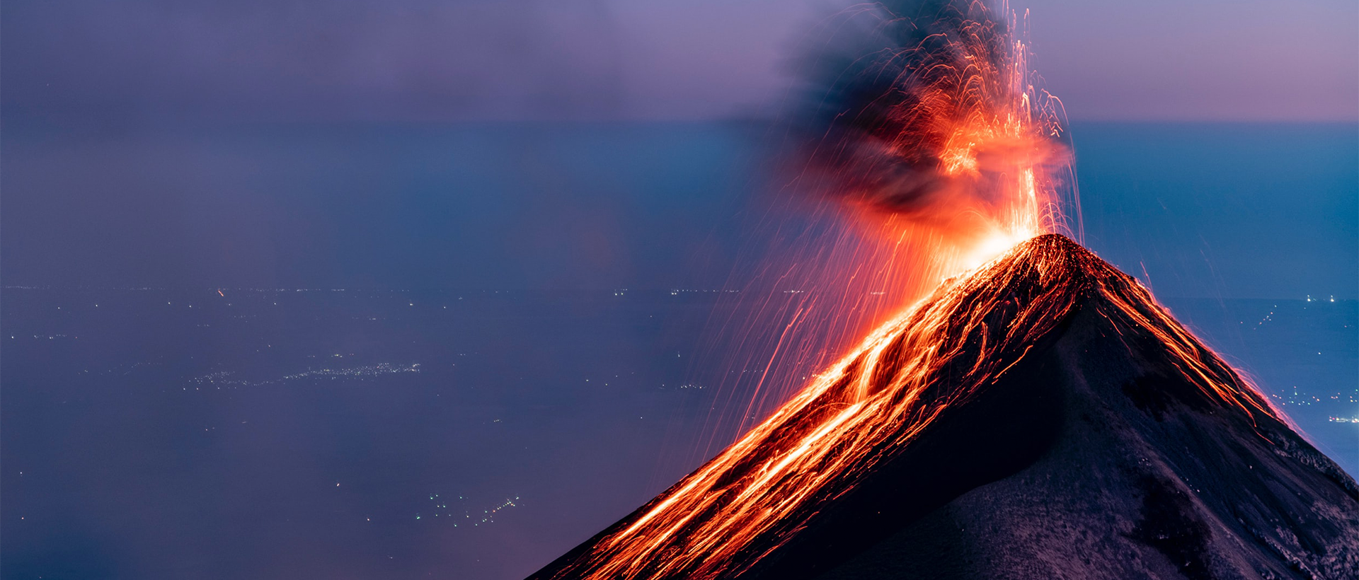 a volcano erupts lava as it erupts into the air.